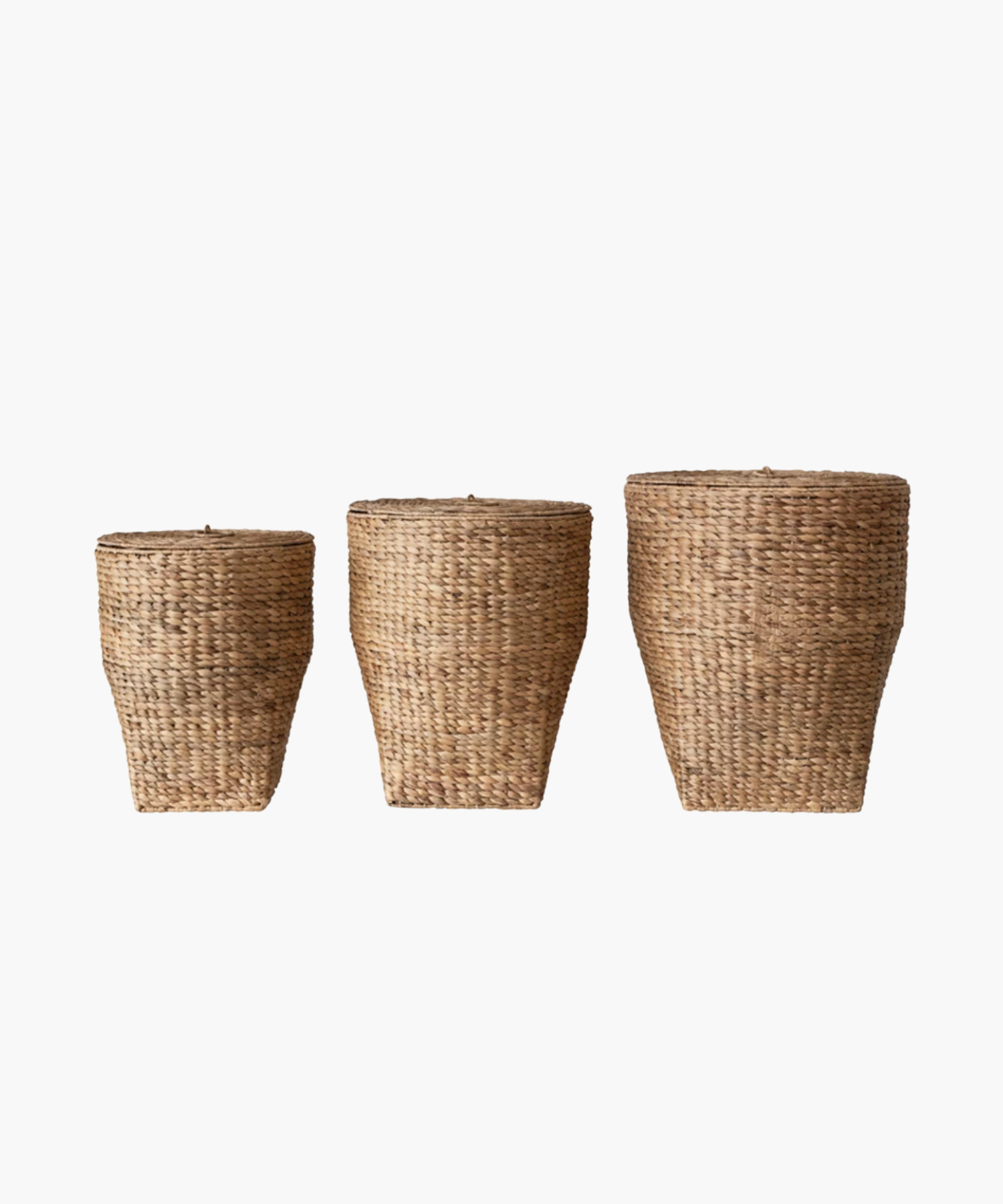 Three woven, conical wicker style baskets of varying sizes with lids are arranged in a row against a white background, displaying natural textures.