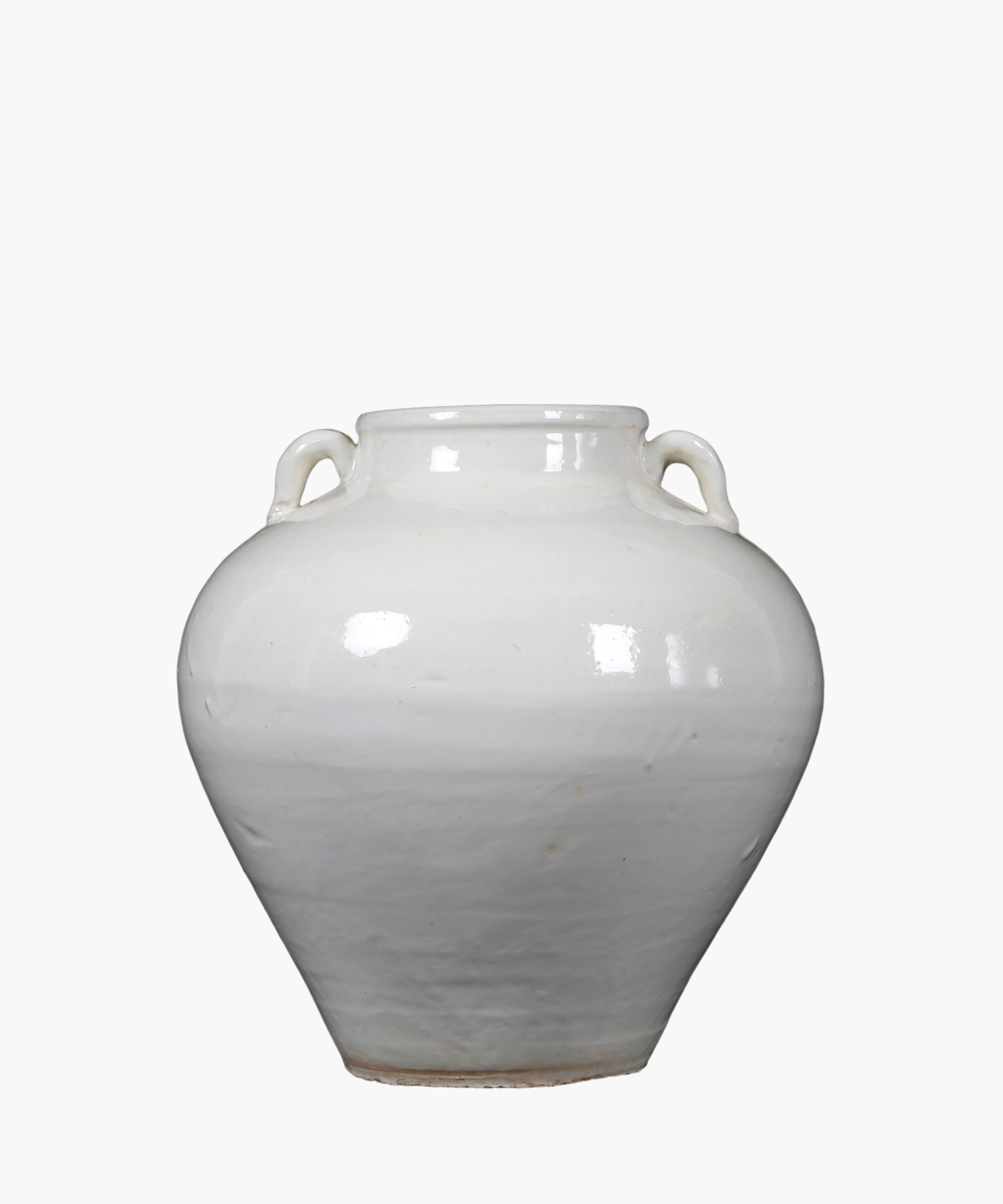 A simple, antique inspired white ceramic vase with two small handles near the neck, reflecting light softly, set against a plain white background.