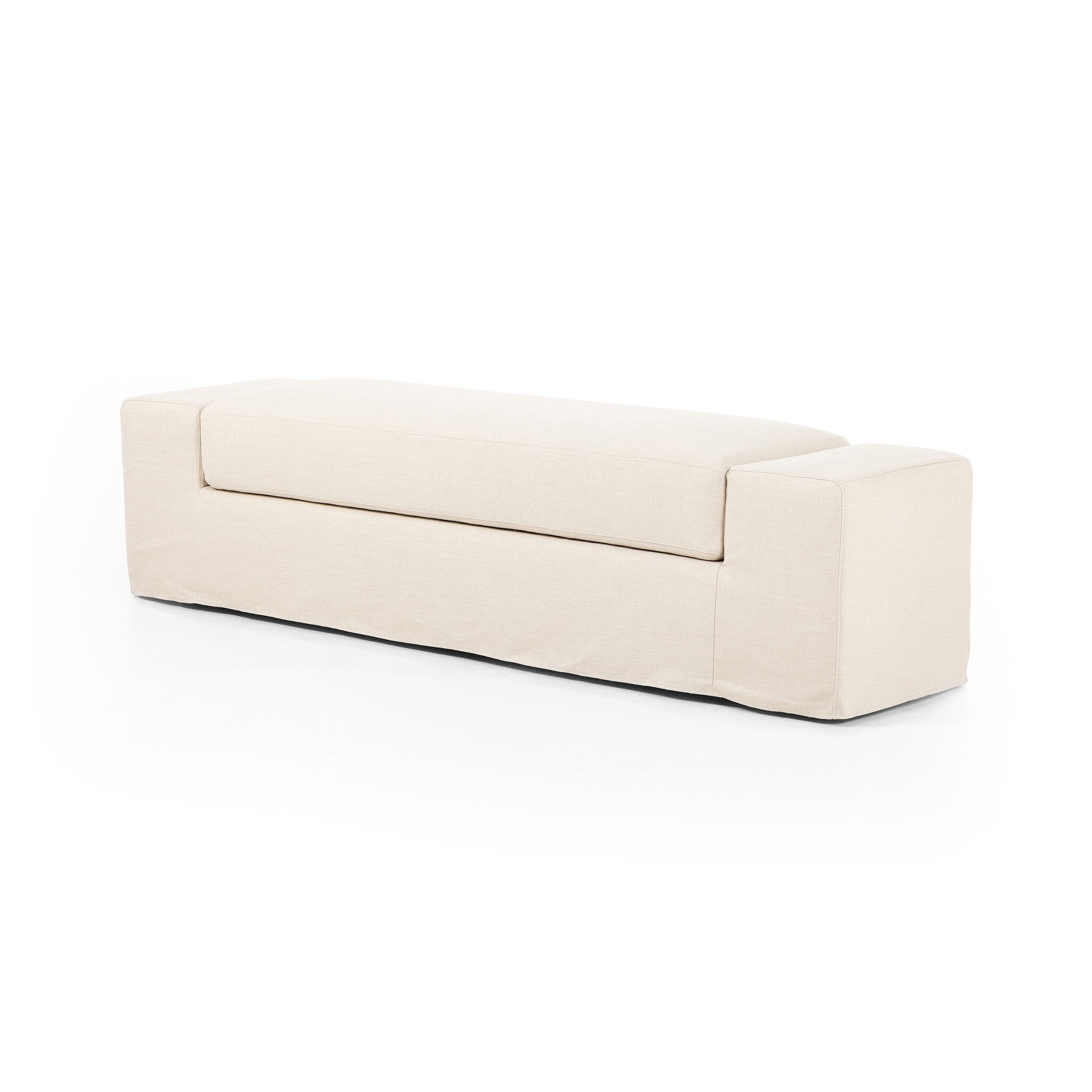 Ivory wide arm slipcover accent bench on a white background. 
