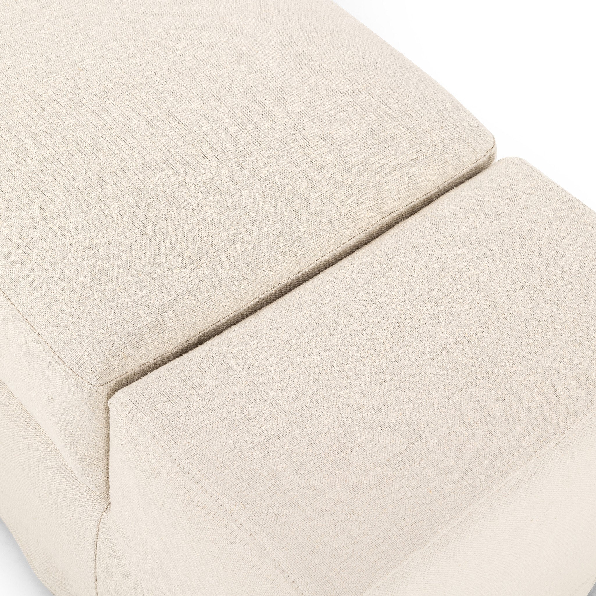 Overhead view of the ivory wide arm slipcover accent bench on a white background. 