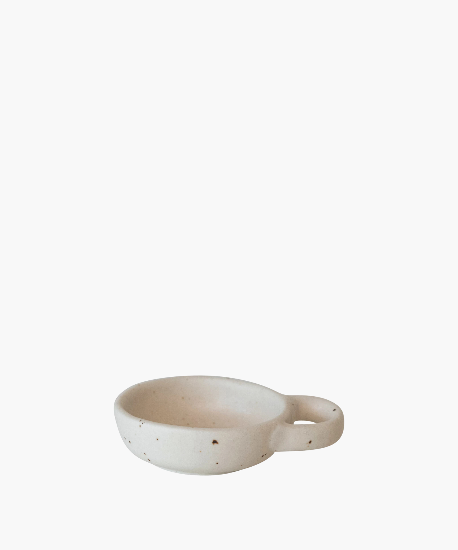 Minimalist ceramic bowl with speckled texture and a round handle on the right side. Its earthy tones convey simplicity and elegance.